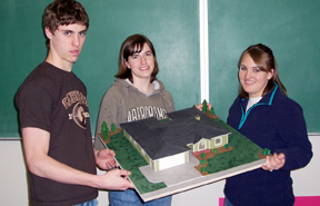 Eric Daly, Alex Richardson and Christa Wilson with the house they along with Chance Ratcliff (not pictured) built using a laser. It took second place for architectural models.