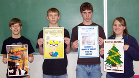 Randy Becker, Steven Baerlocher, Eric Daly and Christa Wilson with their safety posters.