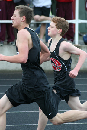Brock Heath sprints down the final straightaway of the 3200. He edged the Highland runner shown at the finish line and finished 2nd.