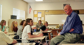 Dr. Terry Armstrong, left, engages a group of seniors and host, Cara Duman (in the back) in a discussion about the importance of protecting their brain cells, especially from alcohol. Once brain cells are destroyed, they do not regenerate like other cells in the body.