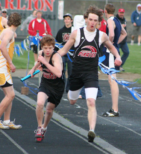 David Sigler hands off to Brock Heath for the final leg of the medley relay. Prairie took third in the event.