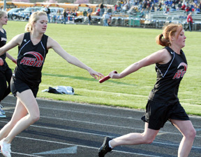 Katie Nuxoll just barely gets the baton to Kayla Lorentz in the 4x200 relay.