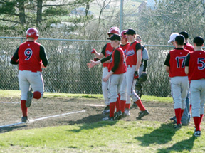 Ronnie Chandler is greeted at home after his homer against Timberline.