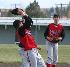 Kyle Holthaus catches a pop-up as Tyler Rogers looks on.