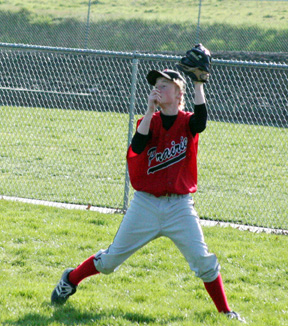 Silas Whitley squeezes a fly ball for an out against Timberline.