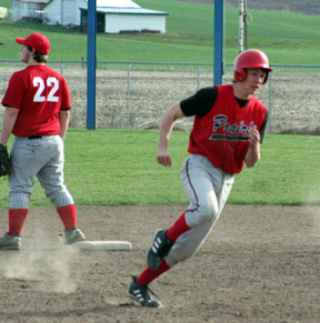Conner Rieman heads for third with a triple against Wallace.