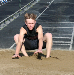 Devin Schmidt lands in the pit in the triple jump. He took second in the event at the White Pine League meet.