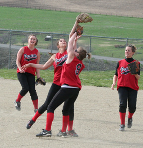 Sam Frei makes the catch as she and Rachel Kaschmitter nearly collide on an infield popup in the Genesee game. At left i Kara Guyer and at right is Alli Holthaus.