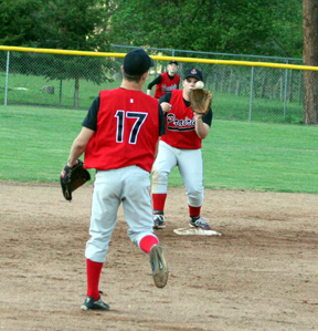 Kyle Holthaus tosses to Joe Schumacher for a forceout at second against Troy.