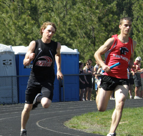 David Sigler runs his leg in the 4x400 relay. Prairie finished third in the event but still qualified for state.