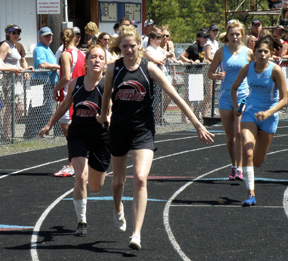 Kayla Lorentz hands off to Katie Nuxoll in the 4x200 relay. They teamed with Kristin Hill and NaTosha Schaeffer to qualify for state in both the 4x100 and 4x200.