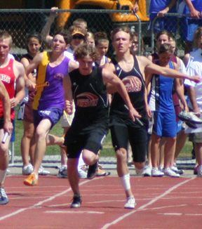 Devin Schmidt has just handed off to David Sigler for the final leg of the 4x100 relay.