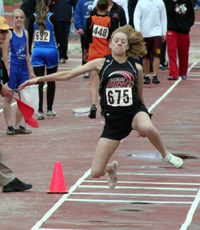 Katie Nuxoll in the triple jump. A rain shower Friday wet down the runway.