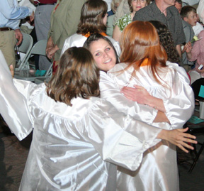 Group Hug! Two classmates hug Brooke Holthaus.