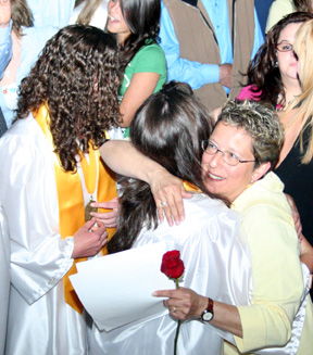 Patty Hinkelman hugs a grad after the ceremonies.