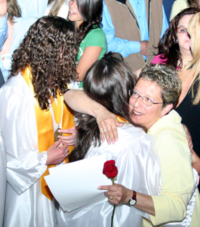 Patty Hinkelman hugs a grad after the ceremonies.