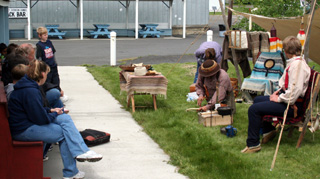 Showing students how to start a fire without matches.