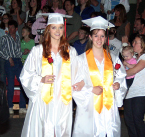 Valedictorians Sarah Arnzen and Jessica Gehring lead the class on to the stage.