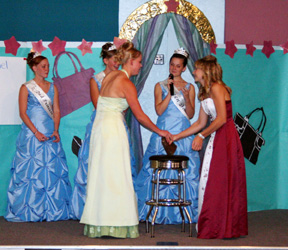Fair Feud was part of the Royalty Nigh entertainment with teams headed by the Royalty candidates. Here Mary Shears and Rachel Kaschmitter both grab the cowbell at the same time to answer the Fair related question posed by Queen Dana Groom.