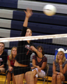 Sam Frei goes high for a spike.