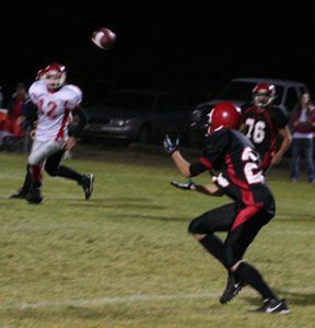 Justin Schmidt is about to catch a pass thrown by his brother Devin. #76 is Colton Nuxoll.