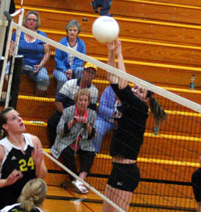 Kayla Johnson looks to block a Timberline spike attempt.