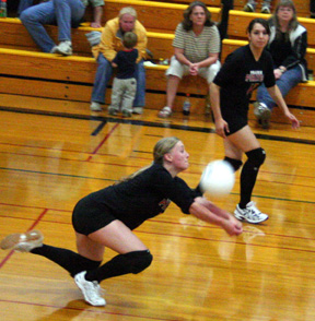 Leora Laurino digs up a serve. At right is Sam Johnson.