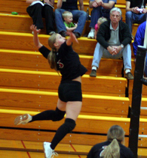 Leora Laurino winds up for a spike attempt. Jennifer Enneking is at the bottom of the photo.