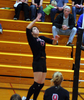 Sam Johnson goes up for a spike. Brianne Stubbers is at the bottom of the photo.