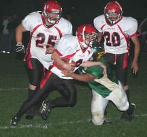 Brock Heath runs the ball with J.C. Enriquez and Tyrell Langston in the background.