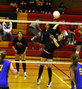 Kaylee Uhlenkott spikes against Nezperce. Sam Johnson is in the background.