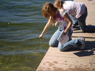 Caitlin Shepard and Nikki Gilmore enjoy a little sunshine while testing the temperature of Payette Lake.
