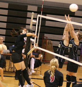 Sam Johnson scores a kill against Highland. At right is Brianne Stubbers.
