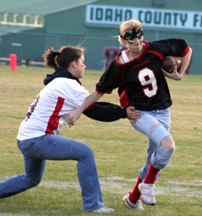 Haleigh Schmidt tackles Katie Nuxoll during the Powder Puff Game.