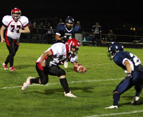 Branden Waller tries to juke his way past a Lapwai defender. In the background is Ronnie Chandler.