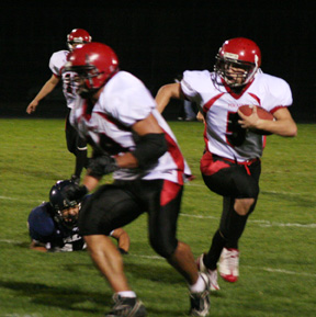 Kyler Shumway leads Kyle Daly on a sweep around left end.