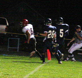 Kyle Daly beats a pair of Lapwai defenders to the goal line for a score.