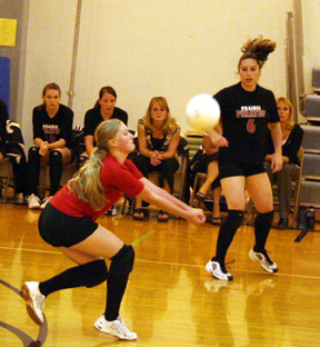 Leora Laurino digs up a Kendrick serve. At right is Kaylee Uhlenkott.