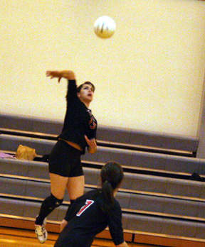 Sam Johnson spikes the ball against Kendrick. In the foreground is her sister Francesca.