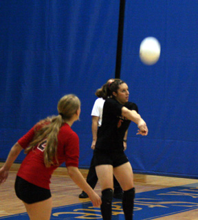 Kaylee Uhlenkott makes a pass. At left is Leora Laurino.