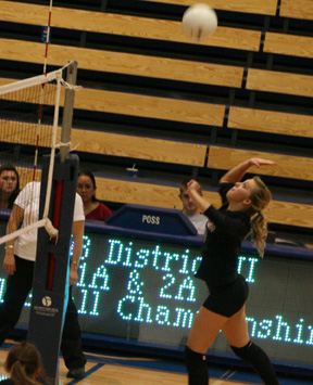 Brianne Stubbers spikes the ball against Deary.