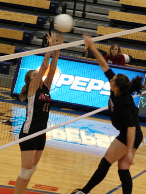 Kaylee Uhlenkott pounds the ball past a Deary blocker.