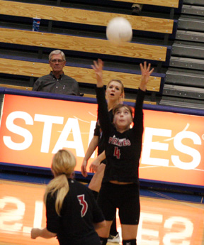 Megan Sigler sets the ball. In front of her is Chelsea Long while behind her is Brianne Stubbers.