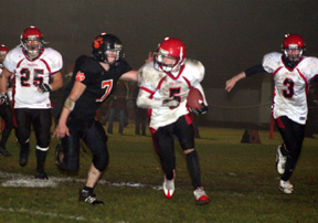 Kyle Daly goes through a huge hole on the left side. At left is J.C. Enriquz and at right is Tyler Forsmann.