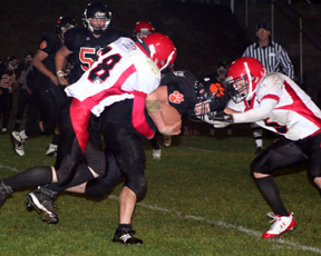 Andy Groom tackles a Kendrick runner with Kyle Daly ready to finish off the play at right.