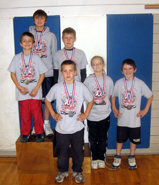 The Cottonwood Wrestling Club medalists at Grangeville. Gold medalists (top step) were Devin Ross and Taylor Heitman. Silver medalist were Hunter McWilliams and Alex Duman. Bronze medalists were Kellie Heitman and Hunter Chaffee.
