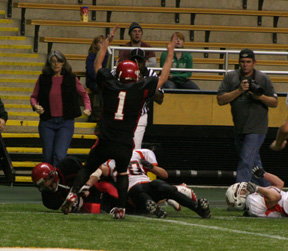 David Sigler signals a touchdown as Kyle Daly scores.