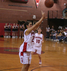 Amber Holthaus scores from the elbow against Kamiah. At right is Megan Sigler.