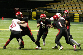 Tyler Forsmann to the left and David Sigler to the right seal off defenders as Kyle Daly breaks through on his way to the first touchdown of the game.