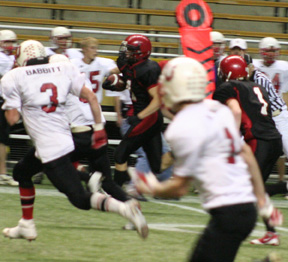 Devin Schmidt races down the right sideline for a 60-yard gain that helped set up the only second half touchdown of the game. At right is David Sigler.